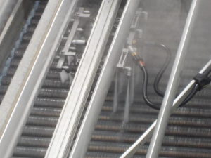 Air cooled condenser cleaning between the heat exchanger and the vents.